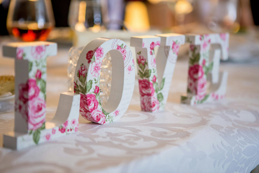 Wooden letters painted with roses spelling the word love