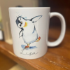 White Mug with Dancing Penguin and Lisa in Script at the Bottom