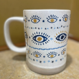 Cream mug with blue eyes and gold pupils